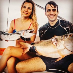 men and woman spearfishing
